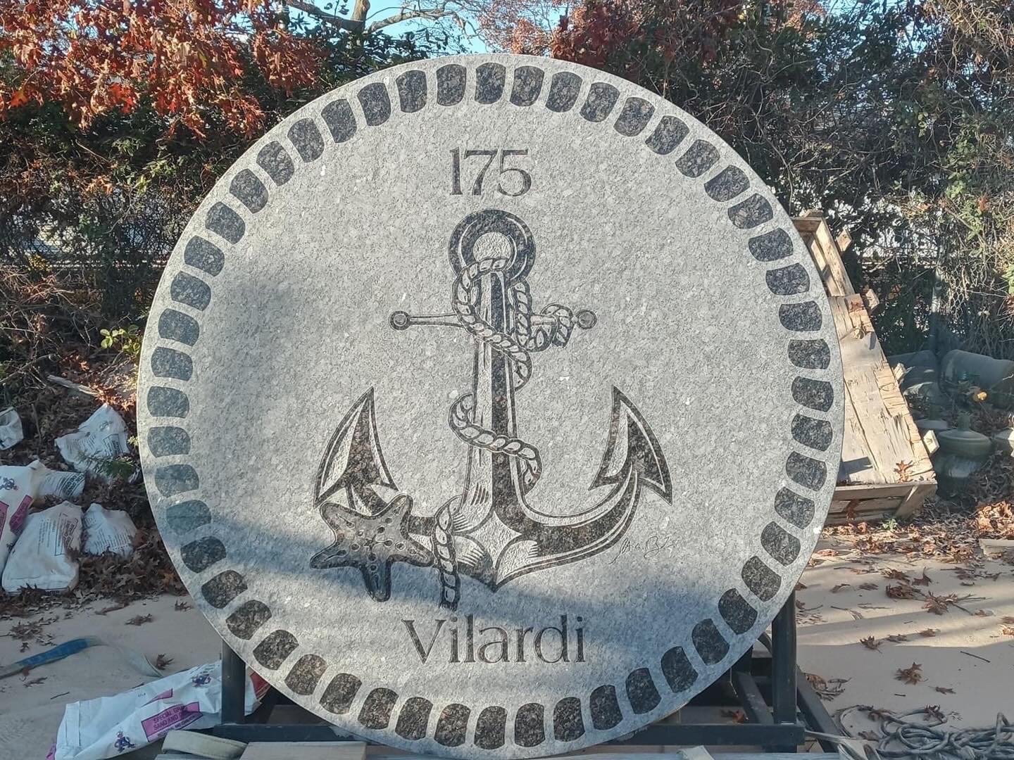 Custom carved granite anchor and starfish medallion with monogram border