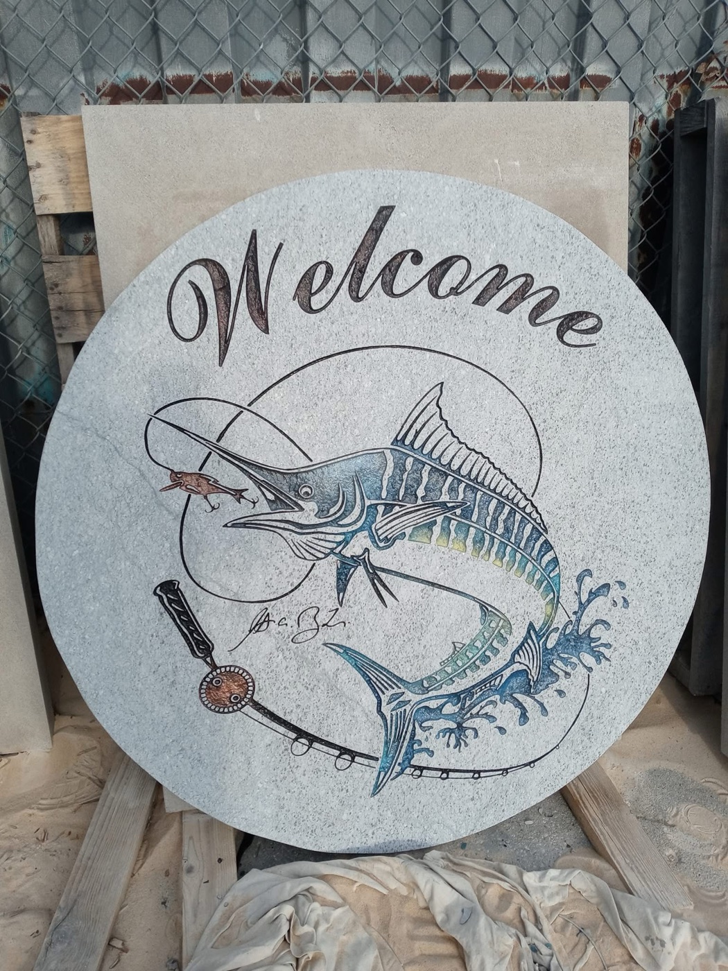 Custom carved granite Welcome sign with a hand-colored marlin and fishing rod design