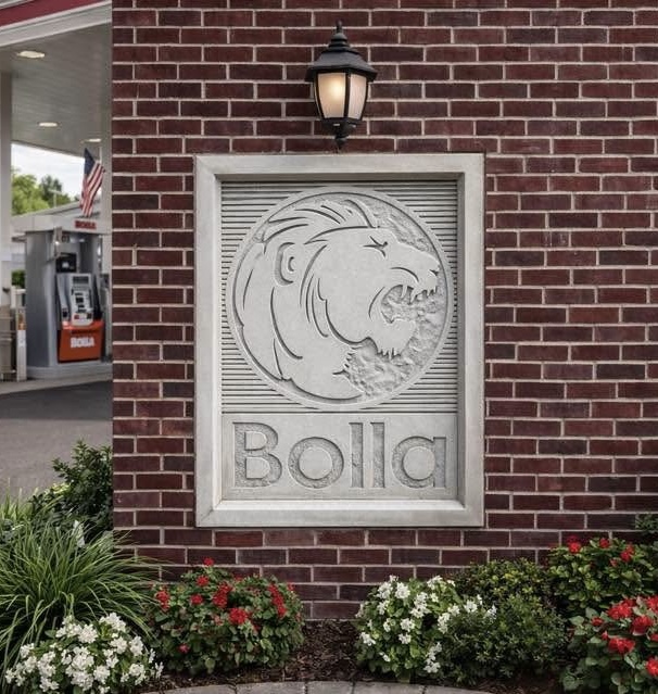 Bolla gas station lion logo carved stone sign set into a brick wall