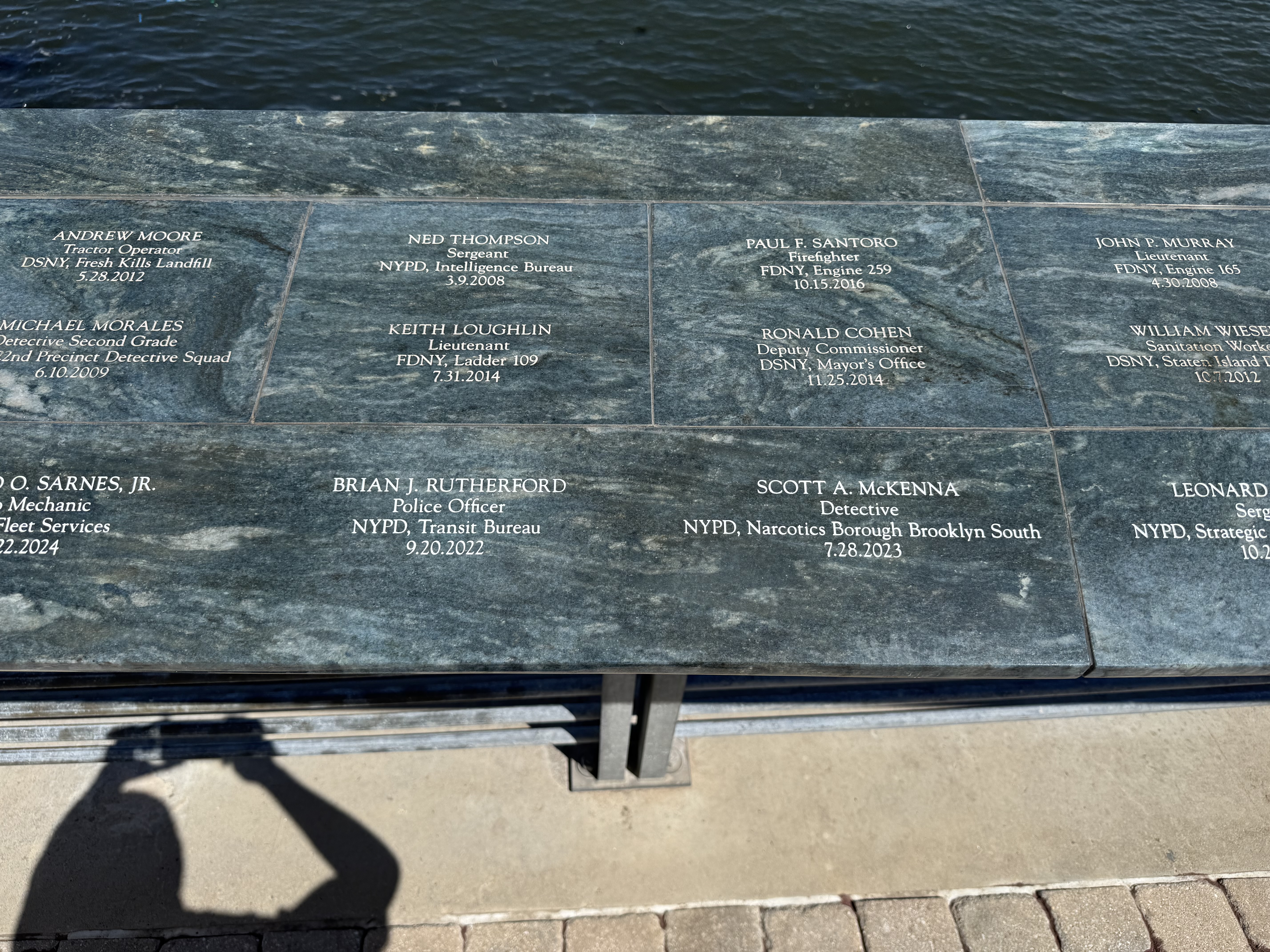 Engraved granite memorial wall honoring fallen NYPD, FDNY, and DSNY members
