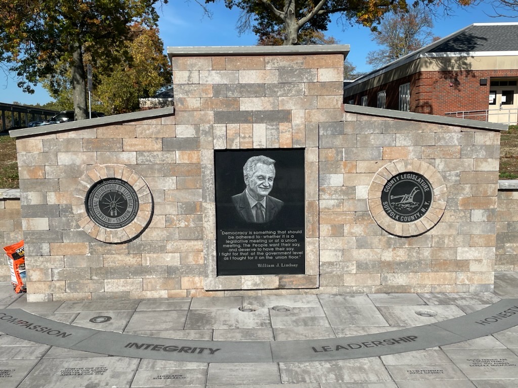 Engraved memorial wall with portrait and dedication plaque