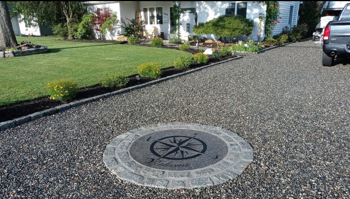 Custom stone inlay compass design set in a driveway