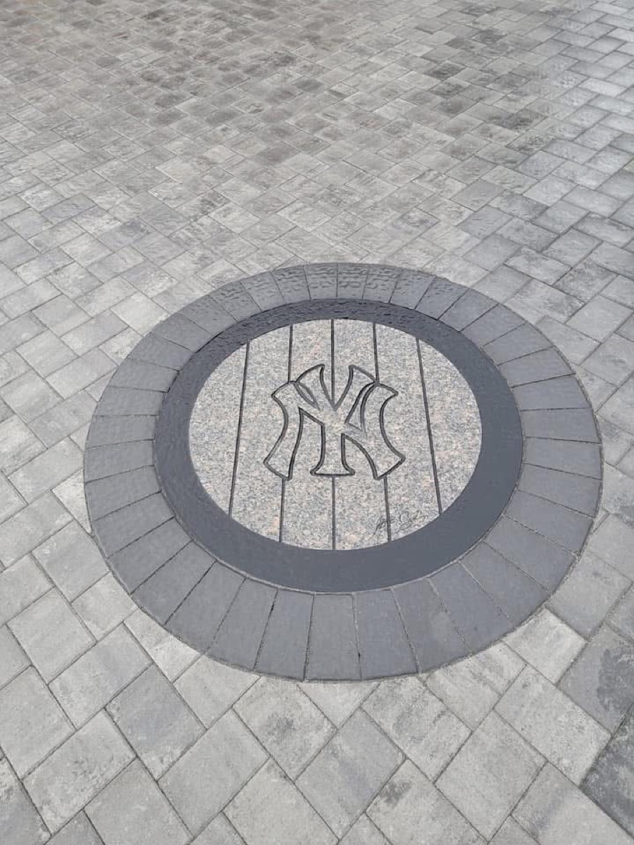 New York Yankees logo medallion inlay in a paver driveway