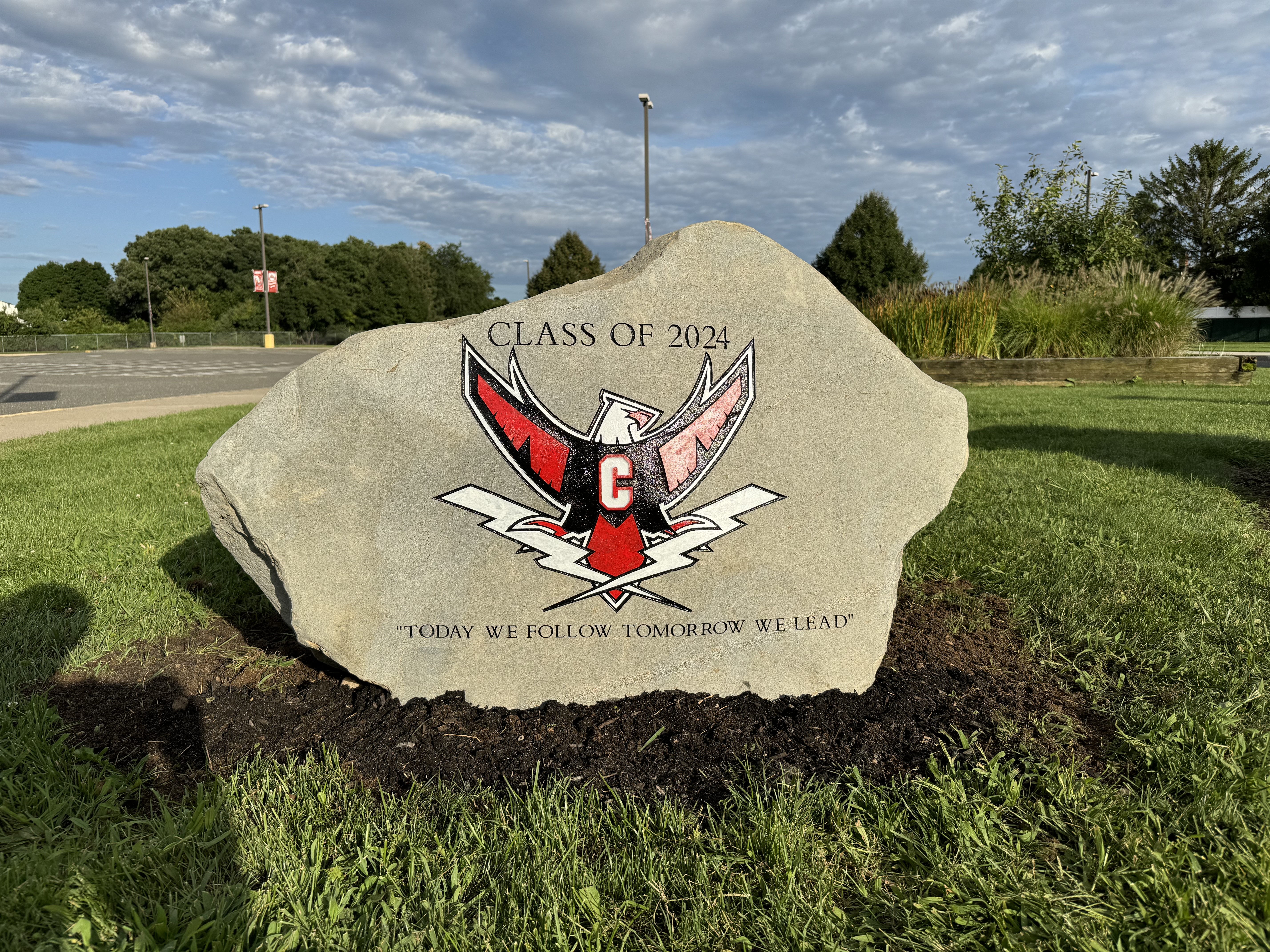 Class of 2024 hawk mascot engraved rock at a school entrance