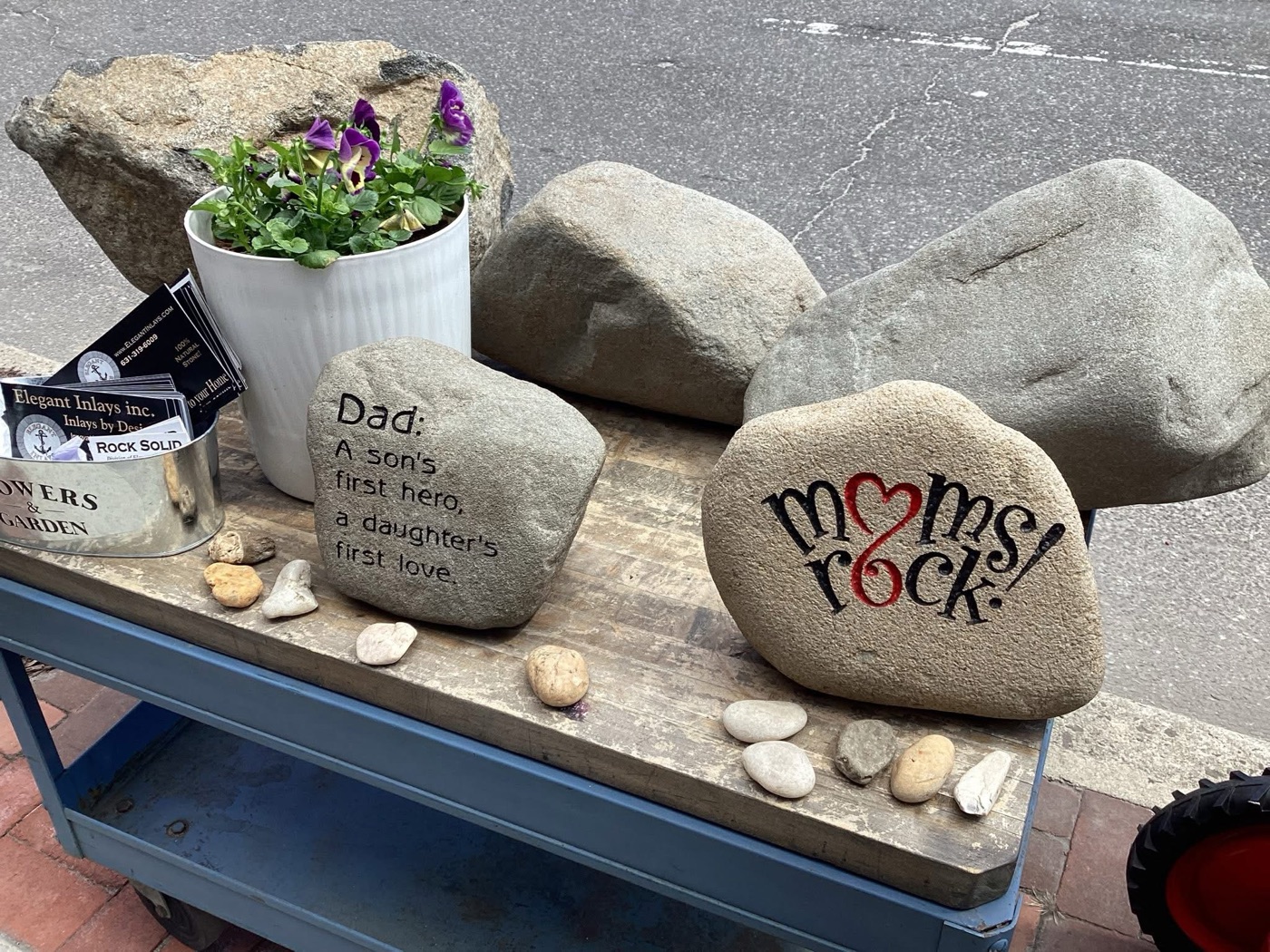 Engraved gift rocks reading Dad, a son's first hero, a daughter's first love, and Moms Rock