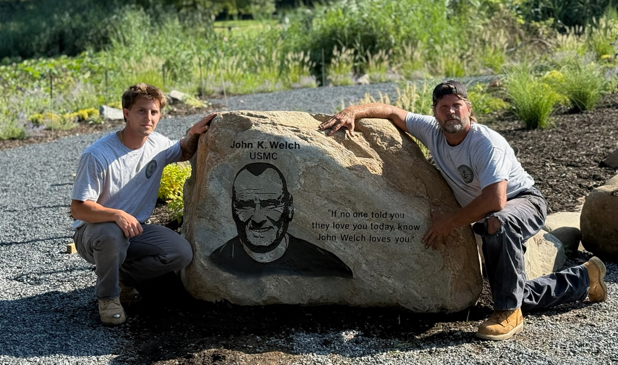 Rock Solid Inc team with a memorial rock honoring John K. Welch, USMC