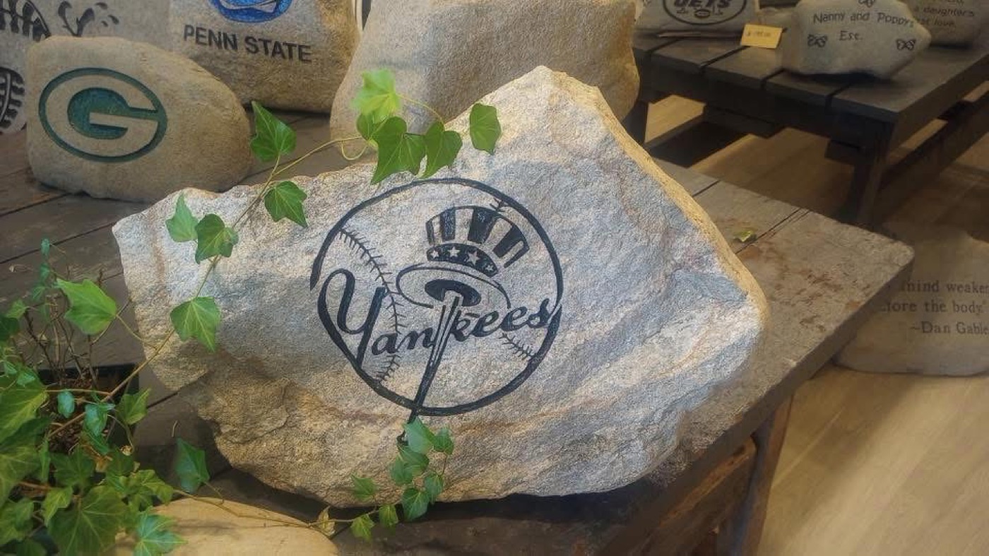 New York Yankees logo engraved rock displayed with ivy in the showroom